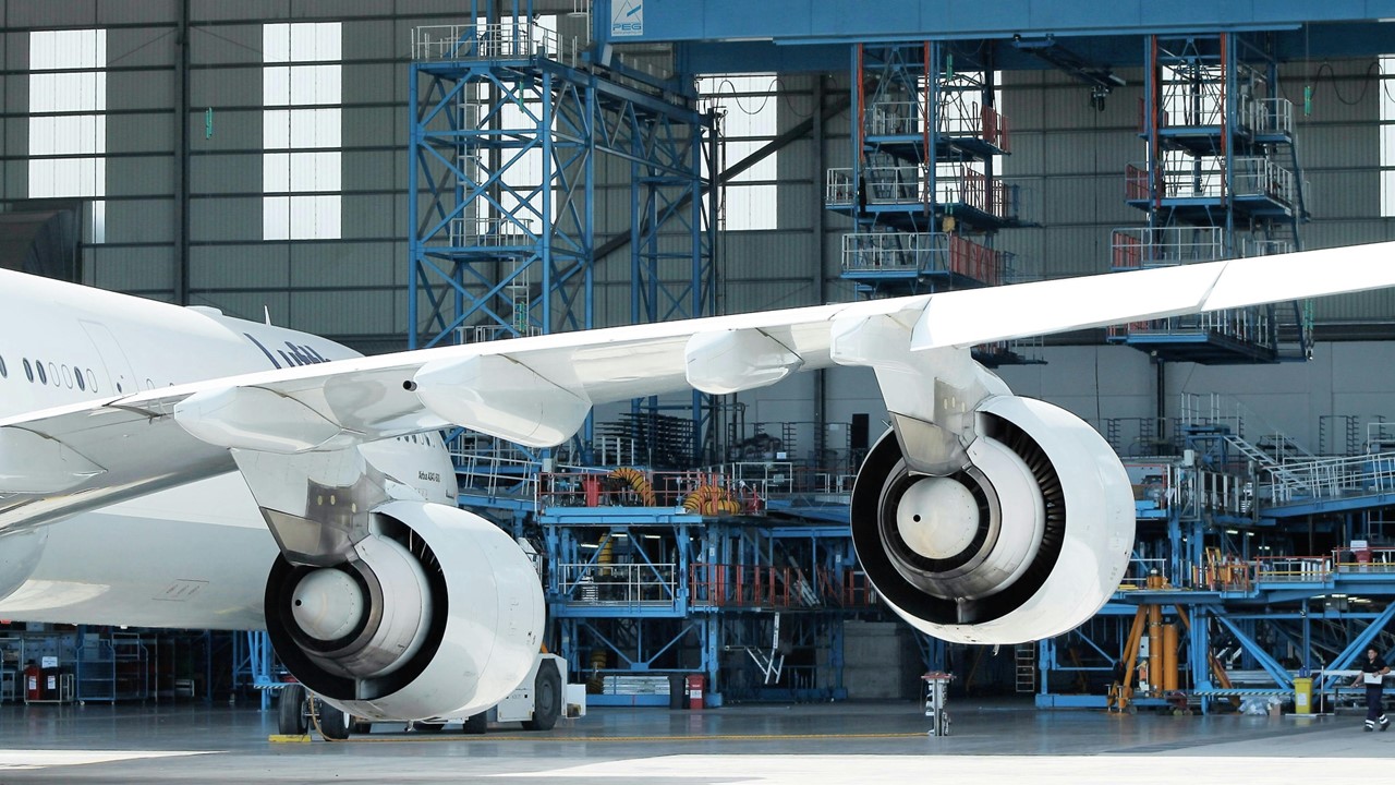 Aircraft in a hangar undergoing maintenance, illustrating the integration of Lean practices for optimizing Aircraft Maintenance Programs and ensuring airworthiness.